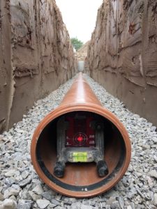 Drainage being laid using a pipe laser